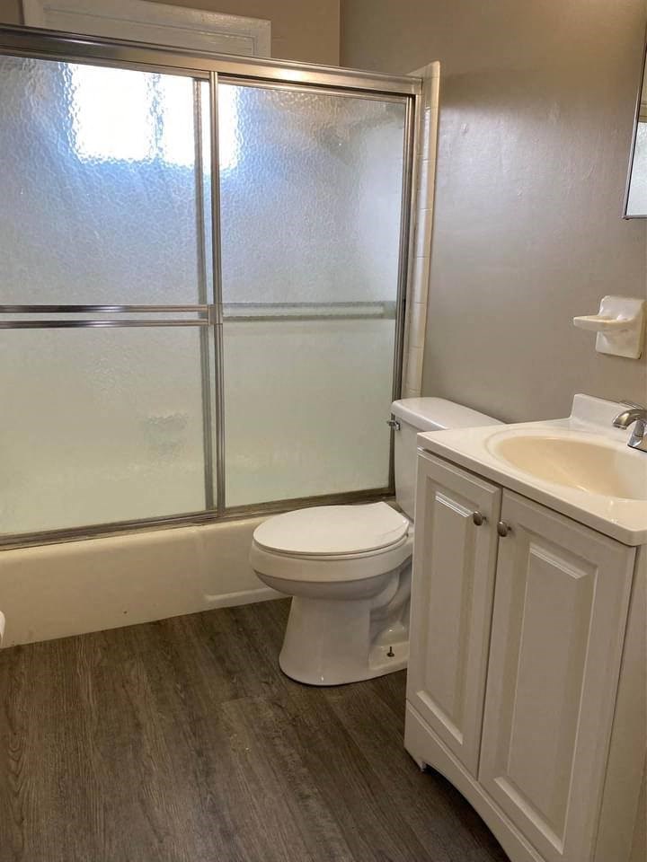 a bathroom with a toilet and a sink and a shower