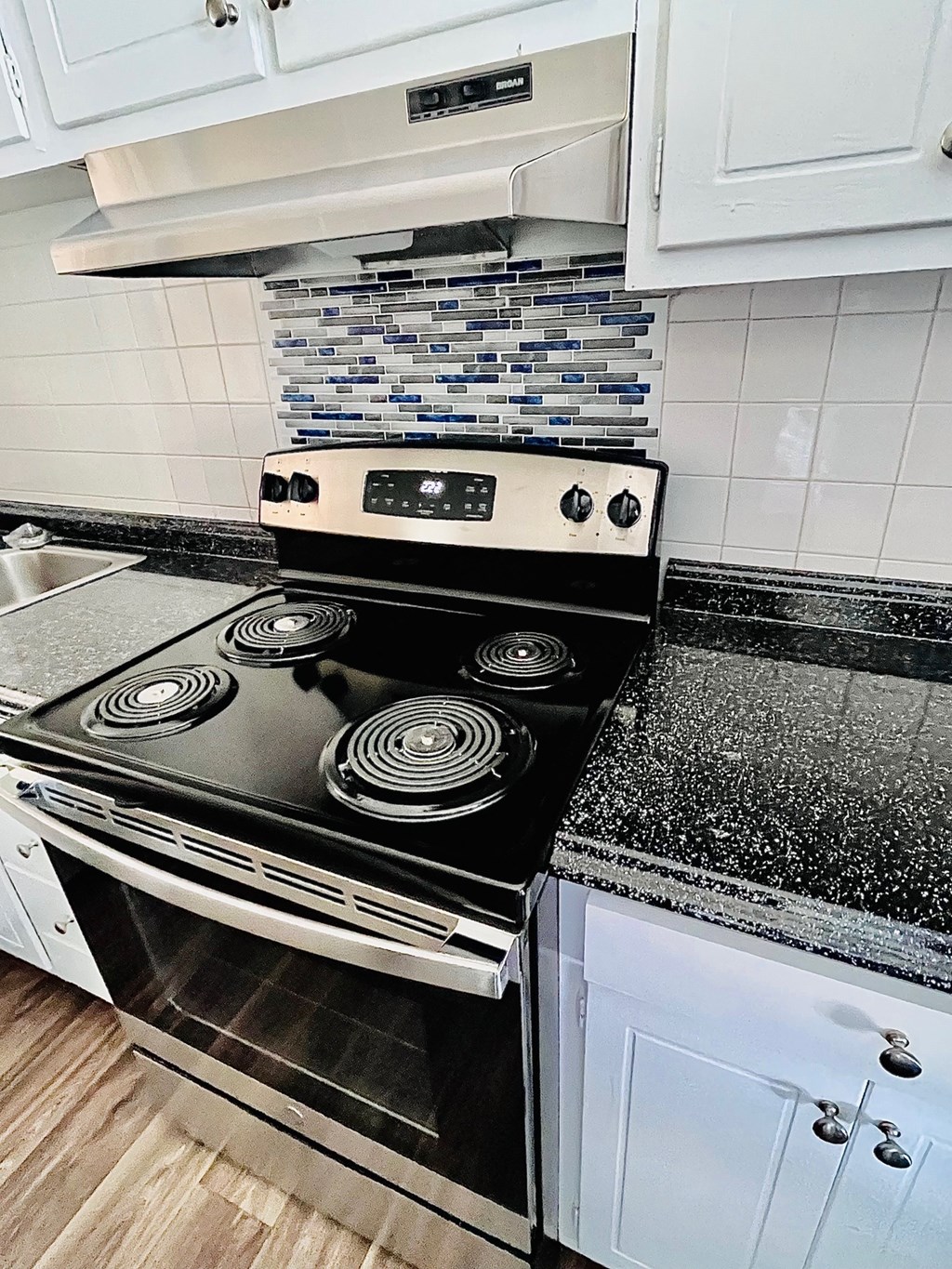 a kitchen with a stove and a sink