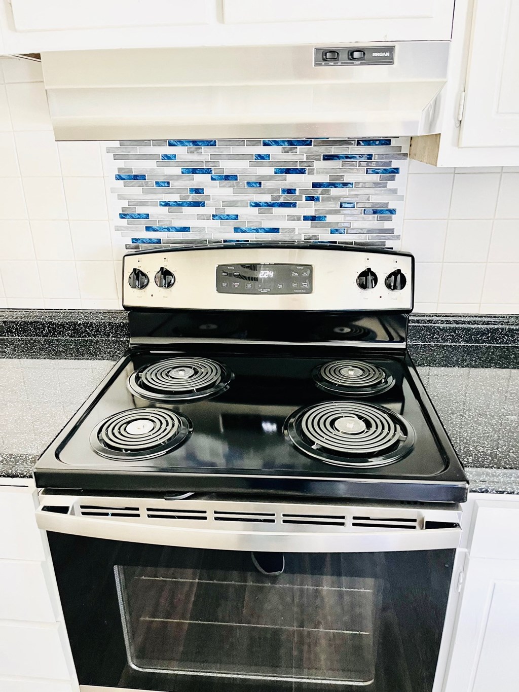 a black and white kitchen with a stove top oven