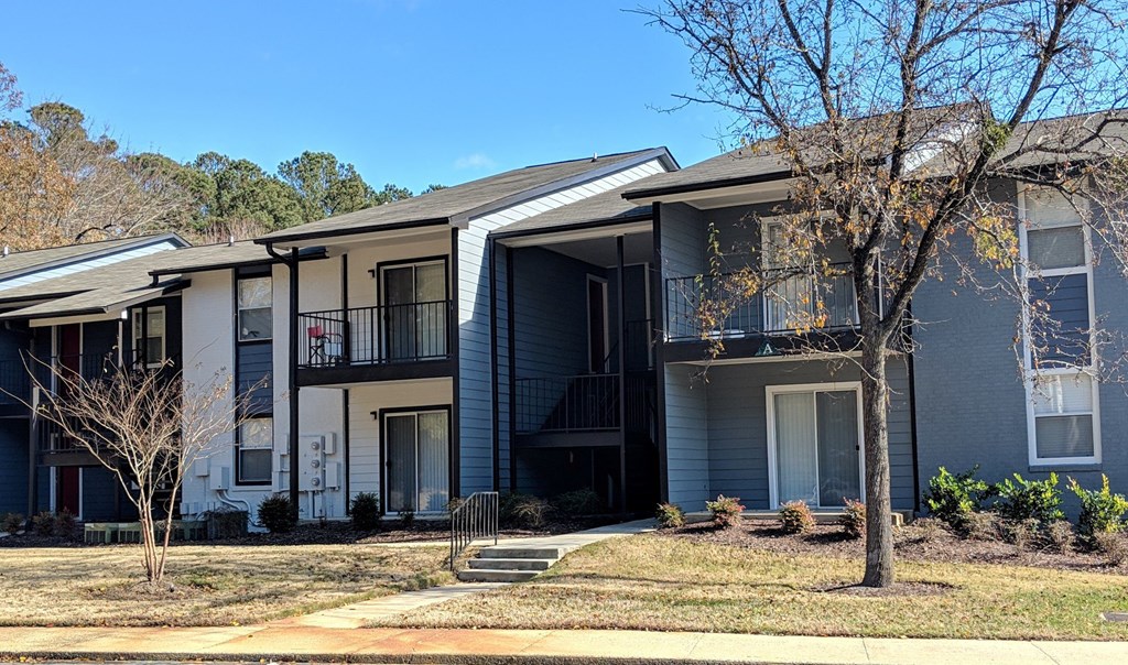 a row of houses with trees in front of them