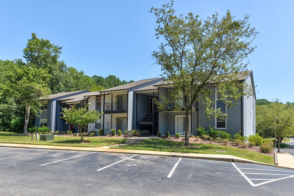 our apartments are located in a large parking lot in front of some trees