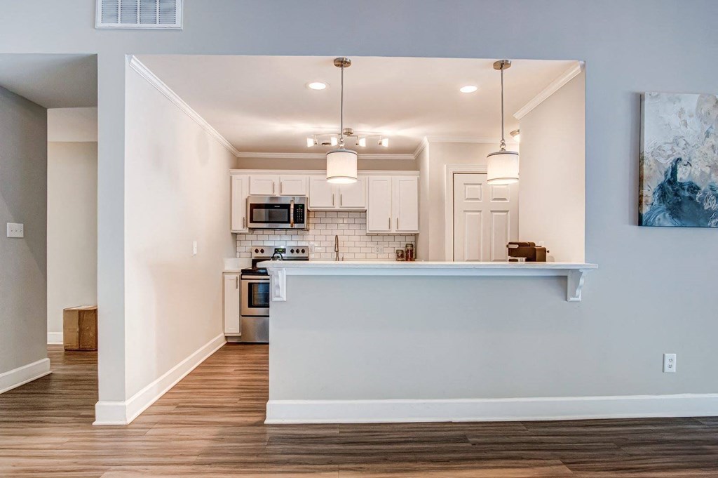 an open kitchen and living room with a counter top