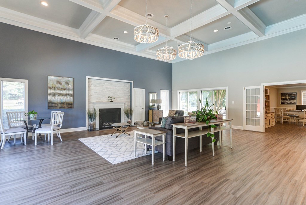 a living room with a fireplace and a dining room