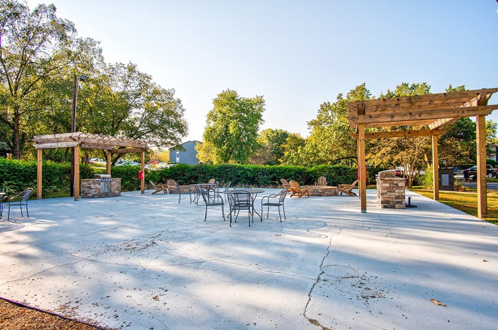 a patio with tables and chairs and a pavilion