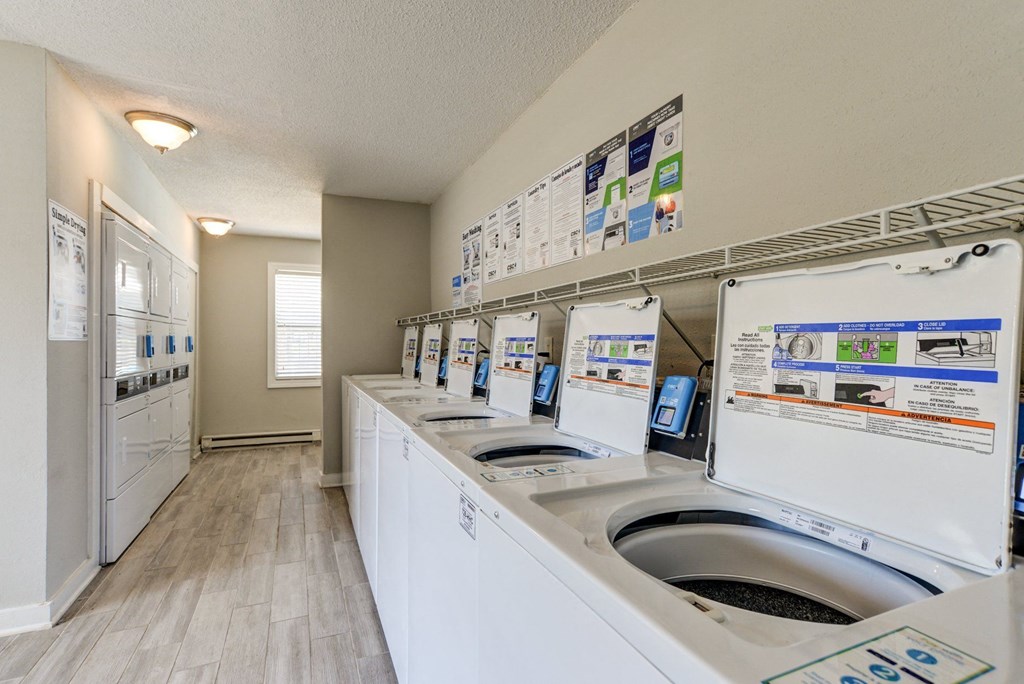 a washer and dryer in a laundry room with washing machines and sinks