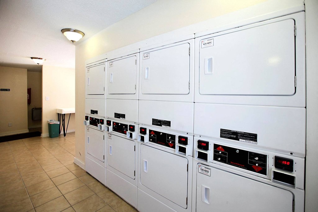 a row of white refrigerators in a room