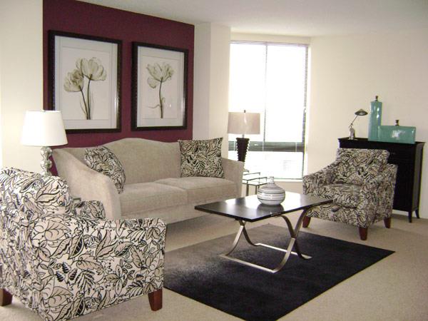 a living room with a couch and chairs and a table