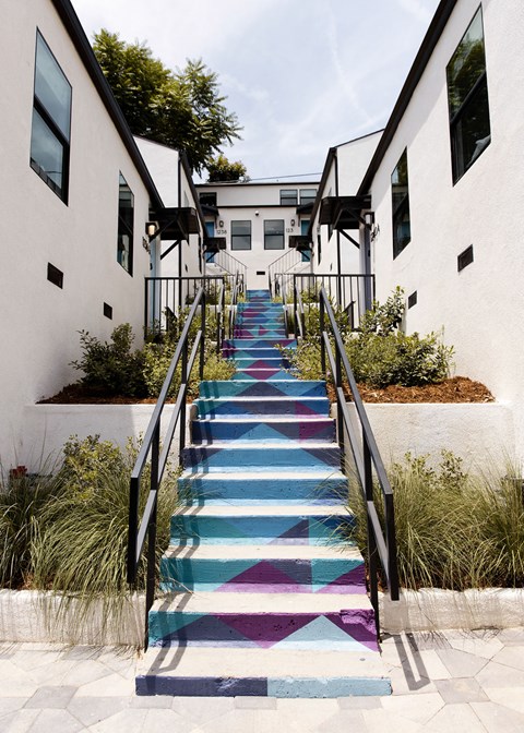 a colorful staircase outside of an apartment building