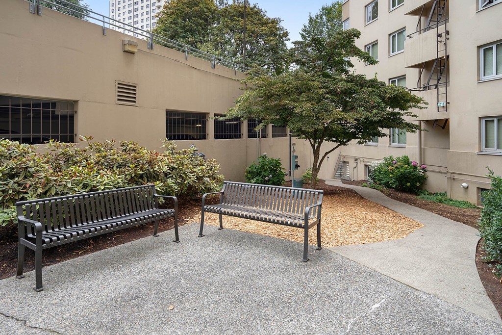 two park benches in front of an apartment building at Celio Apartments, Portland, OR