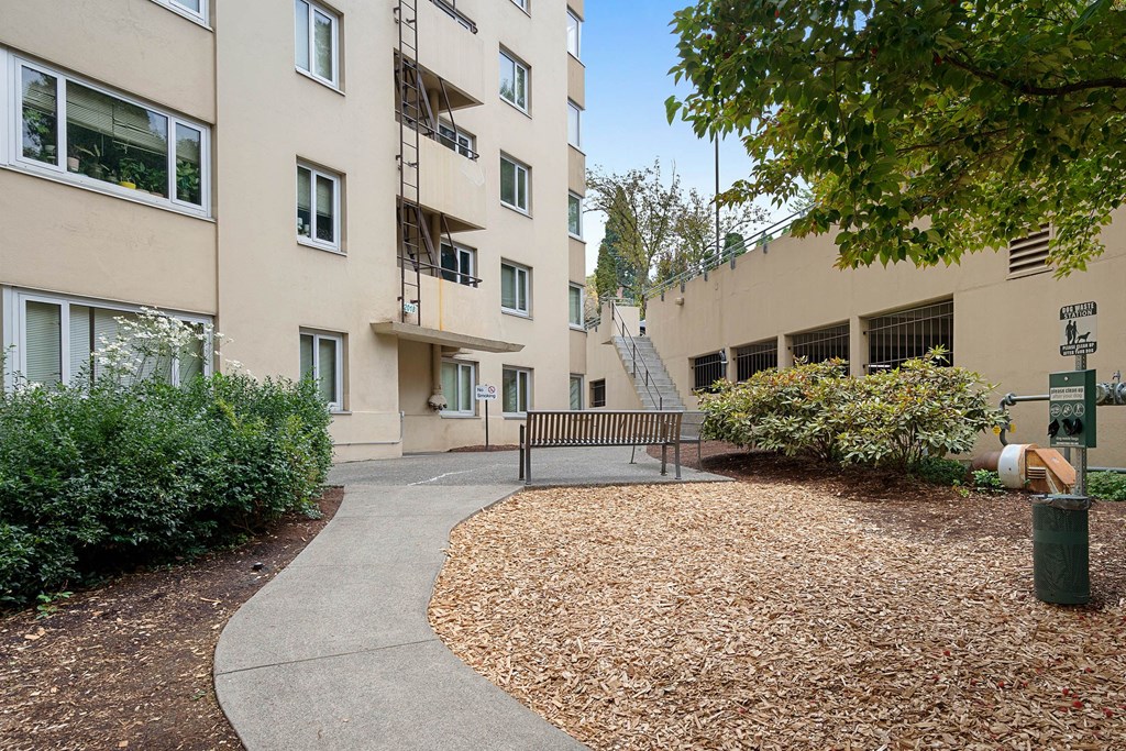 a park bench in front of an apartment building at Celio Apartments, Oregon, 97205