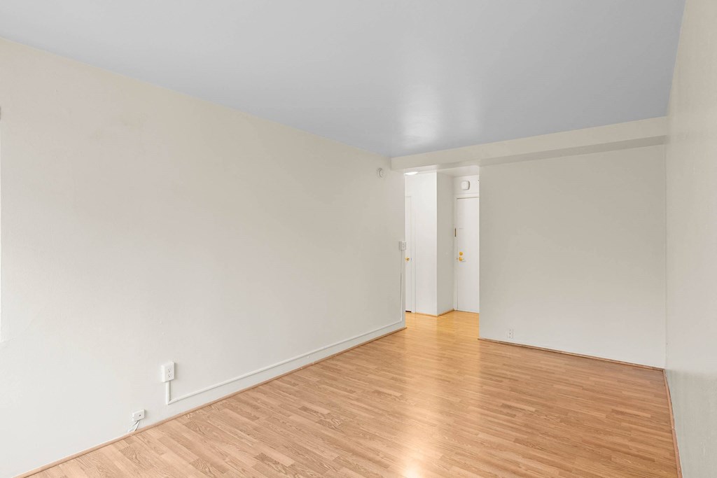 a living room with white walls and wood floors at Celio Apartments, Portland, OR