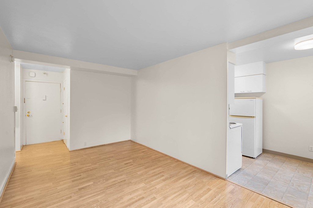 a living room with a hard wood floor and white walls at Celio Apartments, Portland, OR