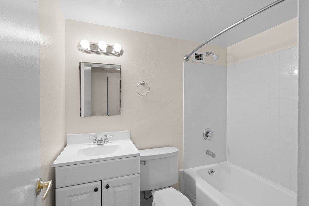 a white bathroom with a white sink and toilet and a tub at Celio Apartments, Oregon, 97205