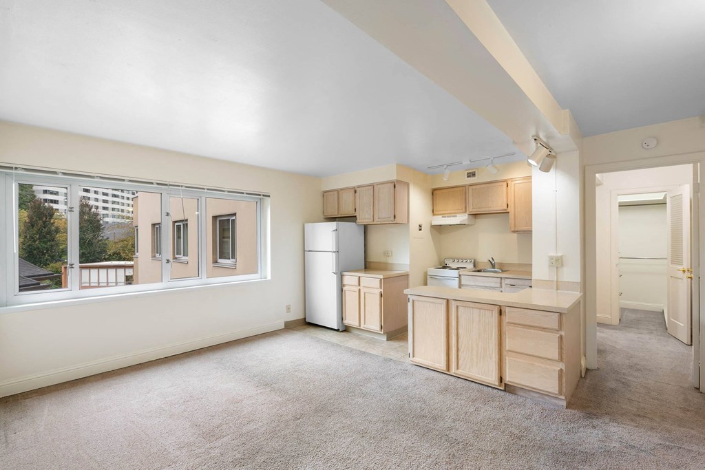 a kitchen with a large window and a sink and a refrigerator at Celio Apartments, Oregon, 97205