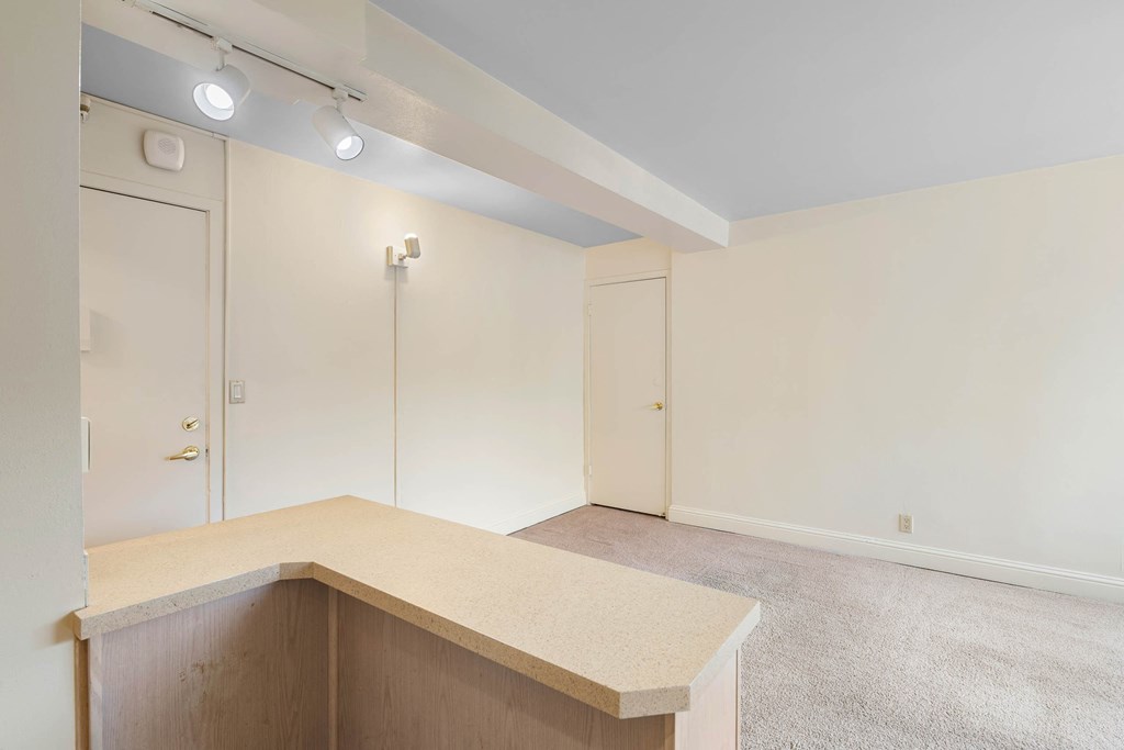 a empty living room with a counter top and a closet at Celio Apartments, Portland, 97205