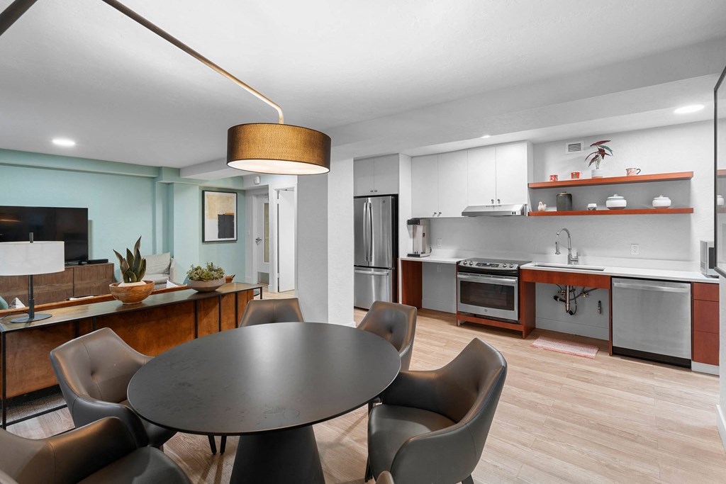 a kitchen and dining room with a table and chairs
