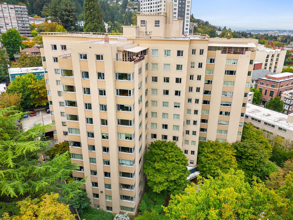 an aerial view of a large building surrounded by trees at Celio Apartments, Portland, 97205