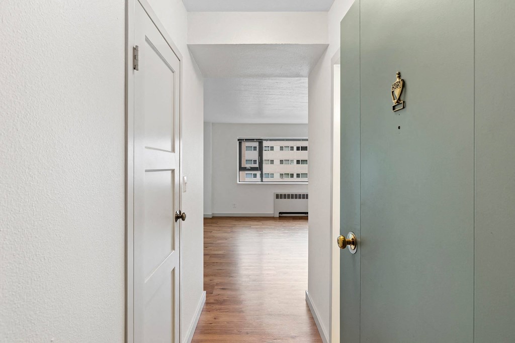 an empty room with a door open to a living room at Vista St. Clair, Portland, OR