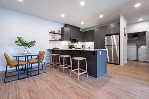 a kitchen and dining room with a table and chairs