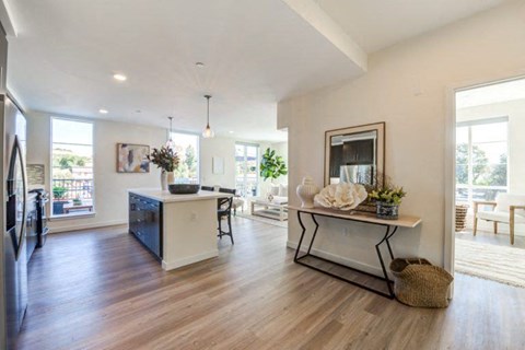 a living room with a kitchen and a dining room