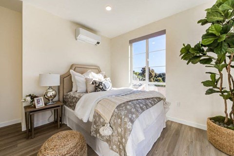 a bedroom with a bed and a window