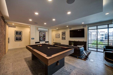 a game room with a pool table and a television