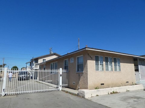 a house with a white fence in front of it