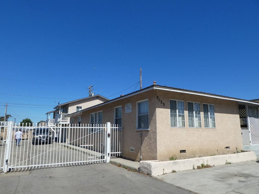 a house with a white fence in front of it