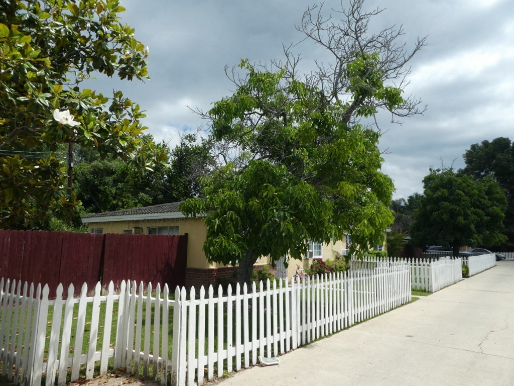 a white picket fence in front of a house
