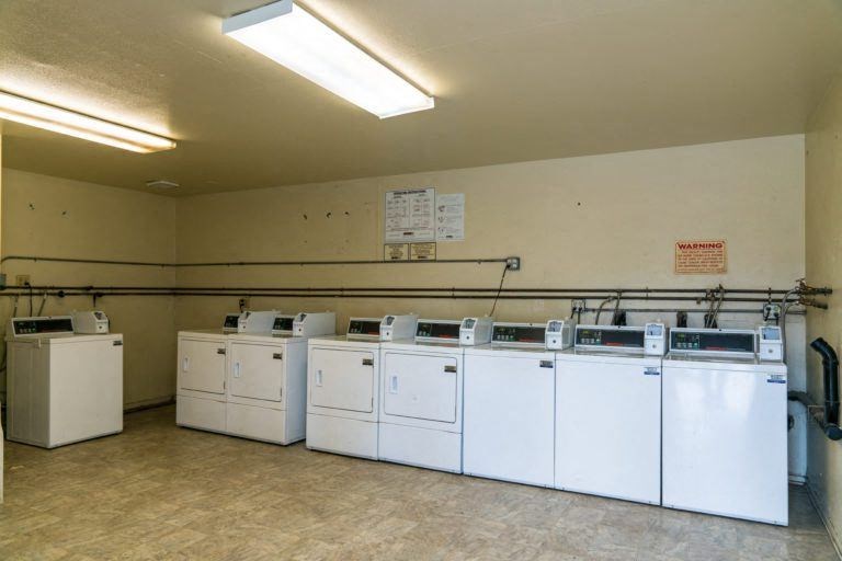 a group of white washing machines in a room
