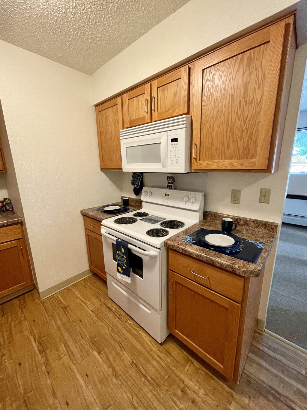 a kitchen with a stove microwave and cabinets