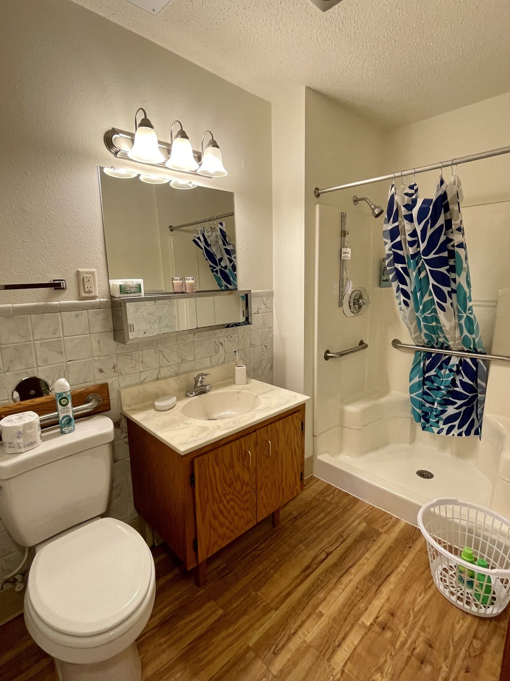 an image of a bathroom with a toilet sink and shower