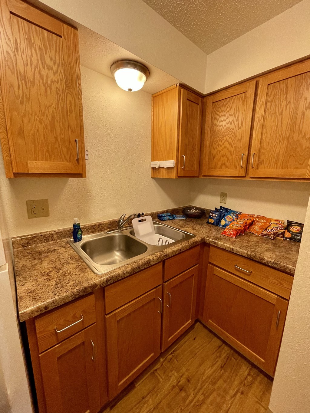a kitchen with wooden cabinets and granite counter tops