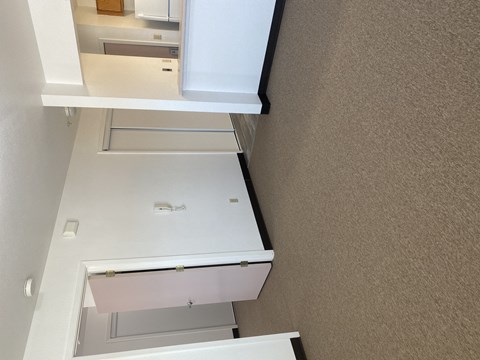 an overhead view of a kitchen with white cabinets and drawers