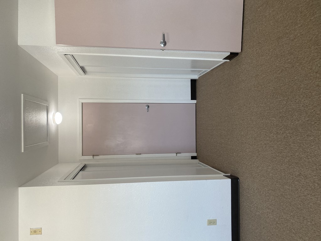 a kitchen with a white refrigerator and a window