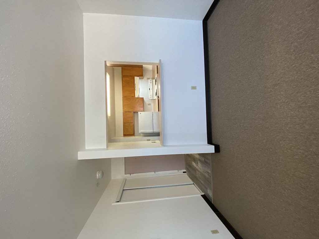 a small room with a small window and a sink and a mirror