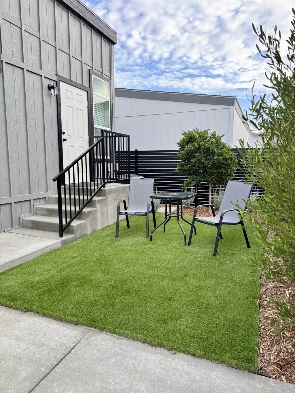 A small patio with a table and chairs.