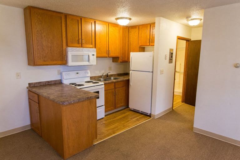 a kitchen with a stove and a refrigerator