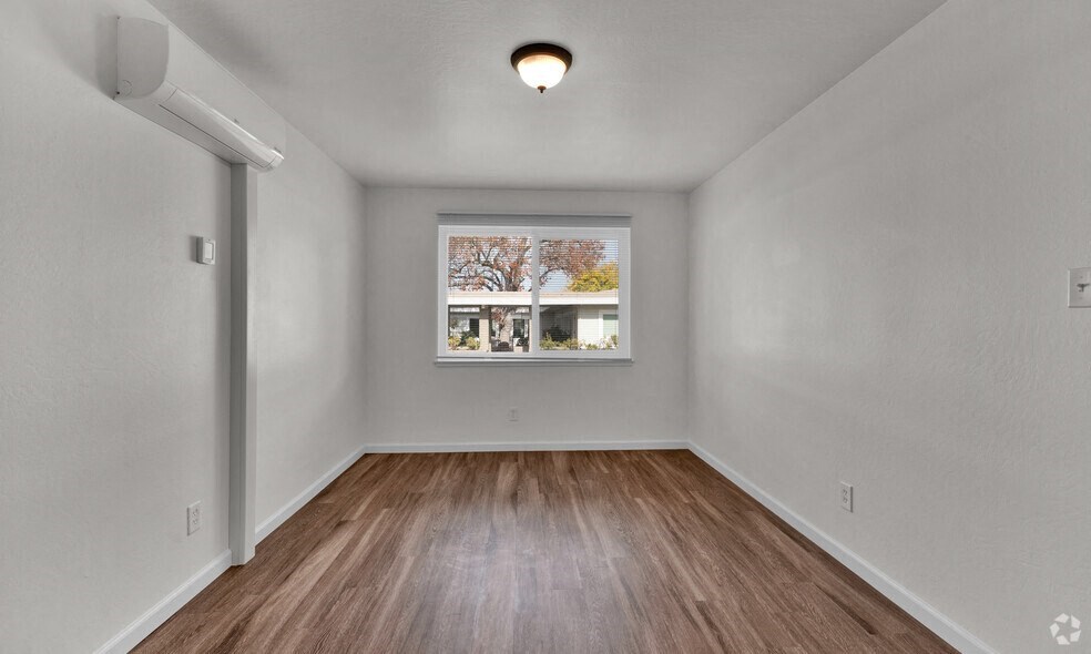 the living room of an empty house with a window