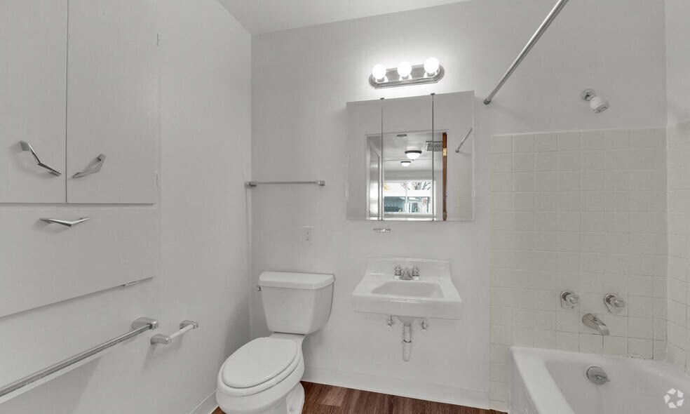 a bathroom with a sink toilet and a mirror