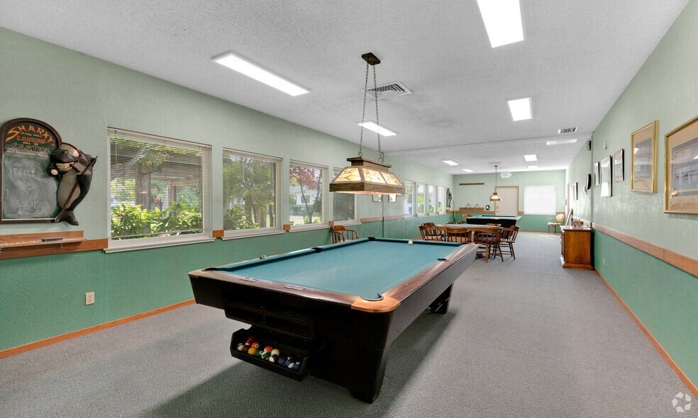 a game room with a pool table and a ping pong