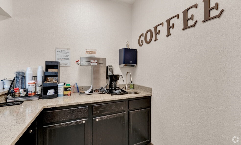 the lobby of a coffee shop with a counter and coffee maker on it