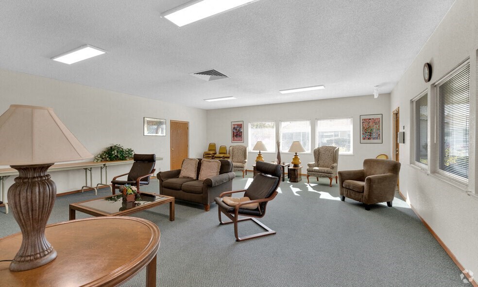 the living room of a house with furniture and windows