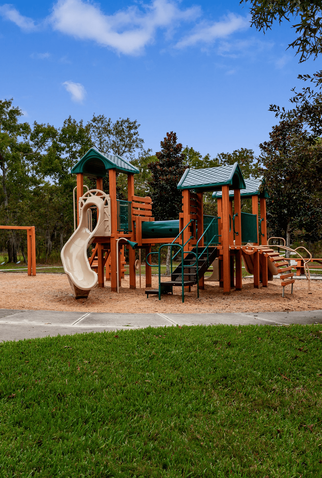 A playground with a green roof and a slide.