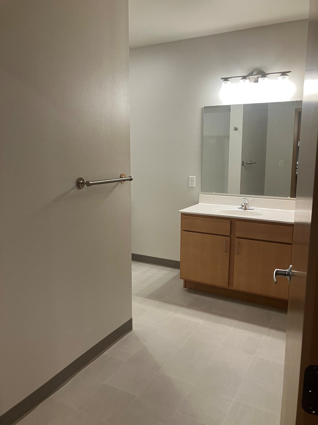 A bathroom with a sink, mirror, and medicine cabinet.