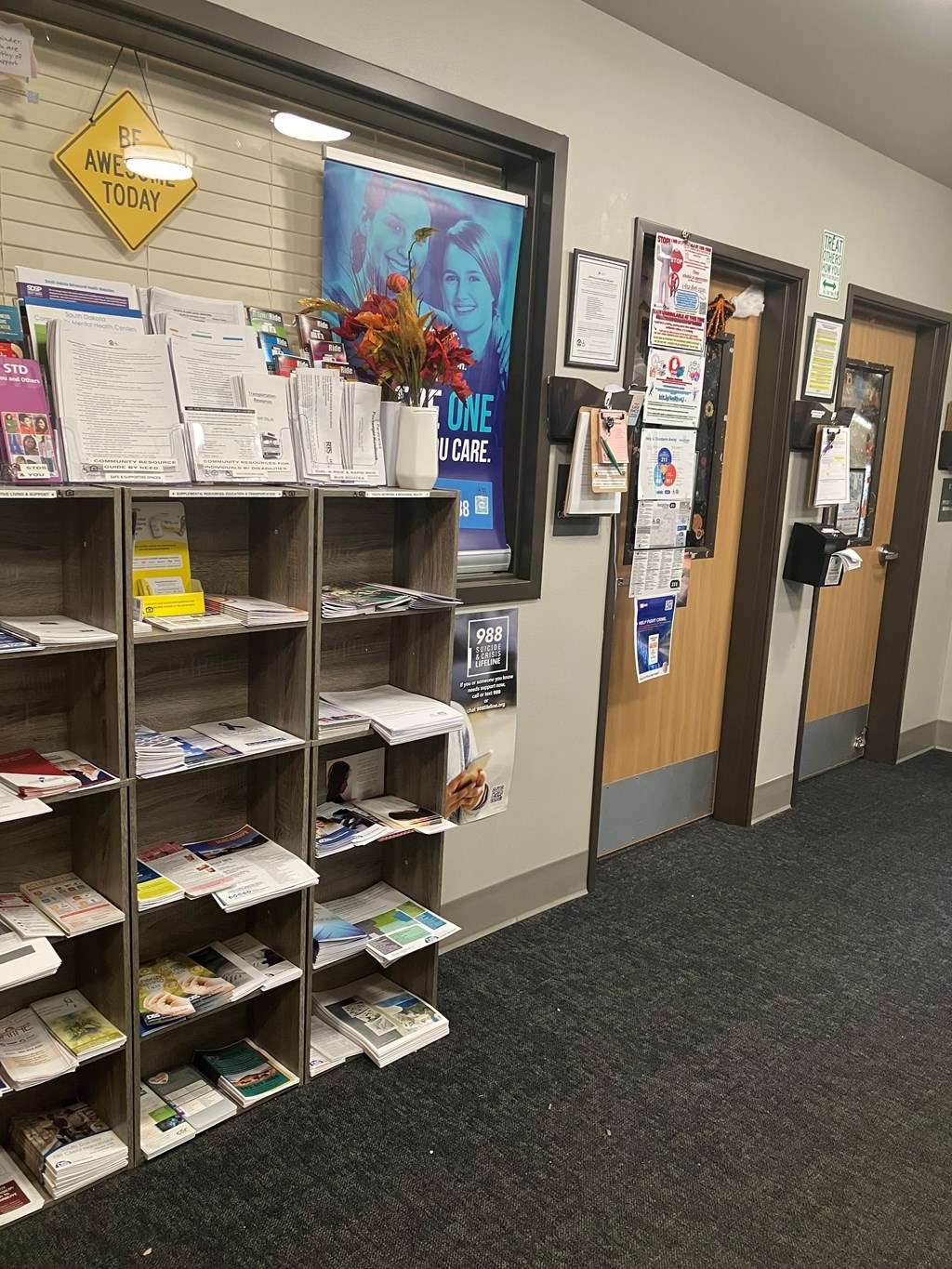 A hallway with a sign that says "E AWESOME TODAY" on the wall.