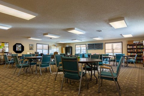 a dining room with tables and chairs in a library