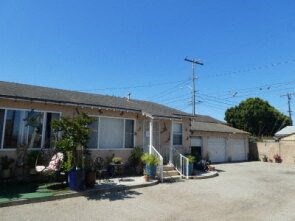 a house with a parking lot and a street