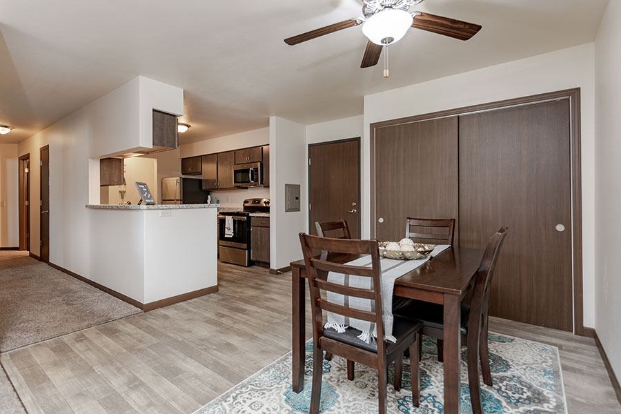 A dining room with a table set for four.