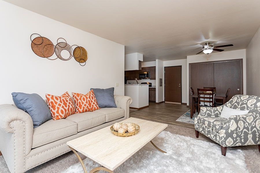 A living room with a white couch and a coffee table.